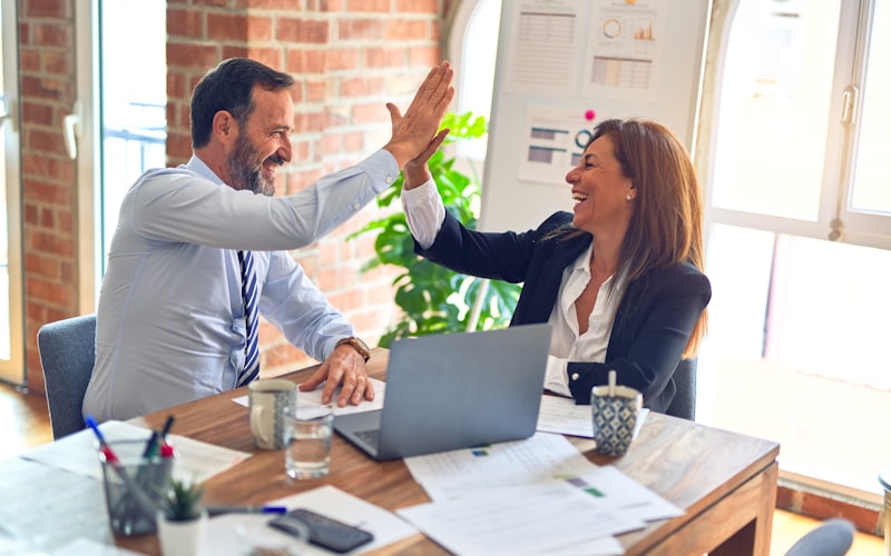 Two colleagues celebrating a closed enterprise deal